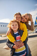 © Viacheslav Yakobchuk - Smiling siblings with their mother close to an aircraft