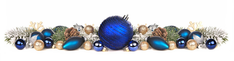 Wall Mural - Christmas border of deep blue and gold ornaments and branches. Side view isolated on a white background.