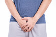 © saran - Man hands holding his crotch isolated white background. Medical, healthcare for advertising concept.