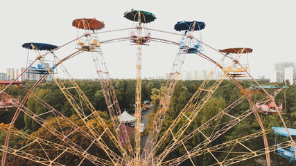 Ferris wheel attraction in the park in autumn from a height.