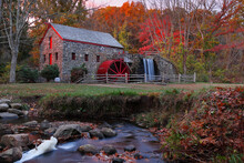 The Wayside Inn Grist Mill With Water Wheel And Cascade Water Fall In Autumn At Sunrise, Concord Massachusetts USA
