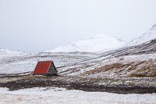 Red Hut In Snow Covered Landscape Of Iceland