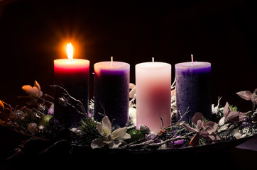 one burning candle on advent wreath