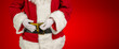 santa claus measures his stomach circumference with a tape measure
