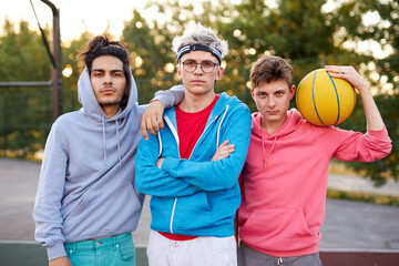 Wall Mural - friendly group of caucasian teenagers boys ready to play basketball, athletic young guys full of energy and strength. people, youth, young generation concept