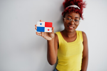 Wall Mural - African american woman with afro hair, wear yellow singlet and eyeglasses, hold Panama flag isolated on white background.
