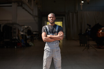 Wall Mural - portrait of confident successful auto mechanic man of african appearance, young male likes working with cars, repairing. take a break, posing at camera