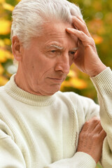 Sticker - Portrait of thinking senior man in park