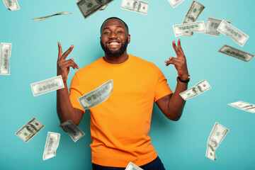 Wall Mural - Boy wins money. Amazed and surprised expression face. Light blue background.