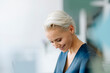 © KNSY/Westend61 - Close-up of smiling businesswoman looking down in office