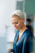 © KNSY/Westend61 - Close-up of businesswoman with short hair working in office