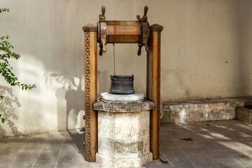 Old water well and copper bucket