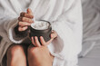© Sky-Blue Images/Stocksy - Closeup of a Woman in bathrobe using a cream