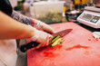© Sergey Filimonov/Stocksy - Unrecognizable cook chopping vegetable in kitchen