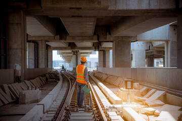 Wall Mural - Engineer under discussion inspection and checking construction process railway switch and checking work on railroad station .Engineer wearing safety uniform and safety helmet in work