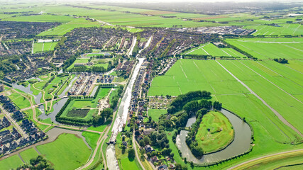 Aerial drone view of Edam town cityscape from above, typical Dutch city skyline with canals, houses and marina, Holland, Netherlands
