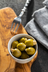 Poster - Pitted green olives stuffed with almonds in bowl.