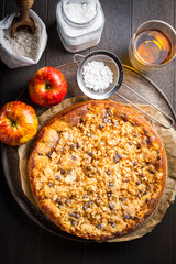 Wall Mural - Delicious apple pie with chocolate pieces and ingredients for Thanksgiving