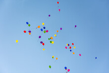 Colorful Balloons In The Blue Sky Fly Away Into The Distance. The Concept Of Freedom Fun And Celebration. A Lot Of Small Balloons. Colorful Abstract Background Of Helium Balloons In A Clear Sky.