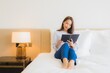 © siraphol - Portrait beautiful young asian woman read book on bed