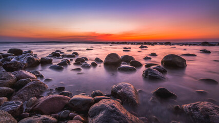 Wall Mural - Colorful sunset over the sea and rocky shore