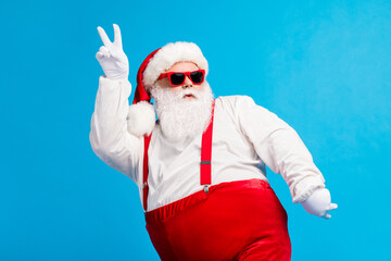 Poster - Photo of cool funky overweight santa claus with big belly beard dance x-mas christmas discotheque wear headwear suspenders overalls sunglass isolated over blue color background