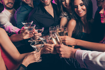 Cropped photo portrait of people clinking champagne glasses indoors
