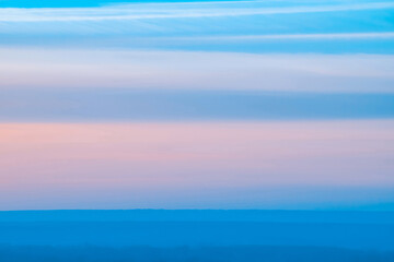 Wall Mural - varicolored striped surreal sky with shades of blue, cyan, pink colors with land. horizontal lines o