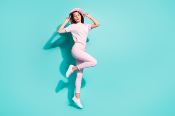 Poster - Full length body size view of her she nice attractive pretty lovely cheerful girl jumping having fun pout lips touching hat isolated bright vivid shine vibrant green turquoise color background