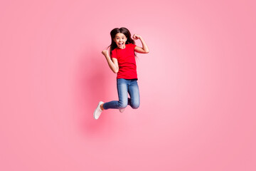 Sticker - Full size photo of delighted kid girl jump raise fists wear casual style outfit isolated over pink color background