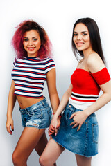 Wall Mural - best friends diverse races teenage girls together having fun, asian and african , posing emotional on white background, lifestyle people concept