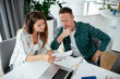 © JustLife - Husband and wife preparing bills to pay. Young couple having financial problems...