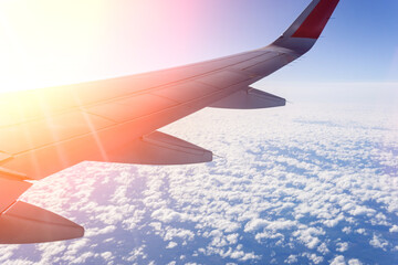 view through the window of the plane, view of the engine. Airplane flying over the sea of clouds. Travel concept