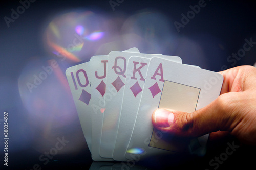Fotografía Man's hand holding a royal flush while playing a winning game at poker