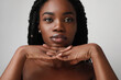 © face_reader_img - Close-up portrait of young black attractive woman, posing over white background. Skin care concept.