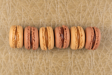 Canvas Print - Six coffee and chocolated flavoured macaroons on vinyl background