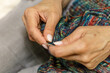 © mitsyko1971 - Close up of hands of unrecognizable woman knitting handmade clothes with spokes using  wool yarn. Concept of leisure activity.Knitting from yarn on  coarse spokes.
