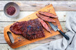 Barbecue wagyu bavette beef steak with red wine salt offered as top view on a rustic wooden board