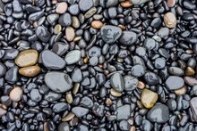 Lot Of Round Grey Wet Stones On A Pebble Beach