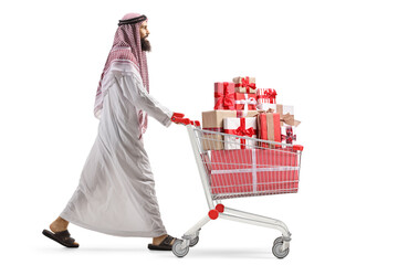 Sticker - Full length profile shot of an arab man pushing a shopping cart with presents