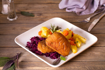 Wall Mural - Roast duck breast fillets with potatoes, carrots and red cabbage. View from above, top studio shot