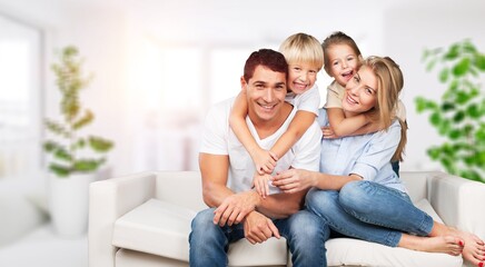 Canvas Print - Beautiful smiling lovely family sitting on sofa