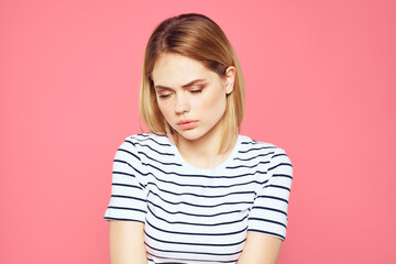 Woman in striped t-shirt emotions studio cropped view lifestyle pink isolated background