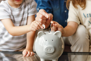 Wall Mural - Crop grandfather and grandchildren saving money.