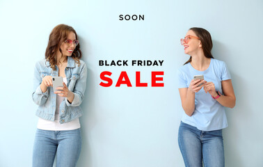 Sticker - Young women with mobile phones on color background. Black Friday sale