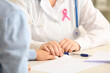 © Pixel-Shot - Young woman visiting doctor in clinic, closeup. Breast cancer awareness