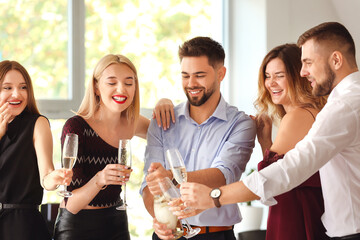 Canvas Print - Young people drinking tasty champagne at party in office