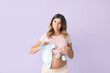 © Pixel-Shot - Beautiful pregnant woman with baby clothes on color background