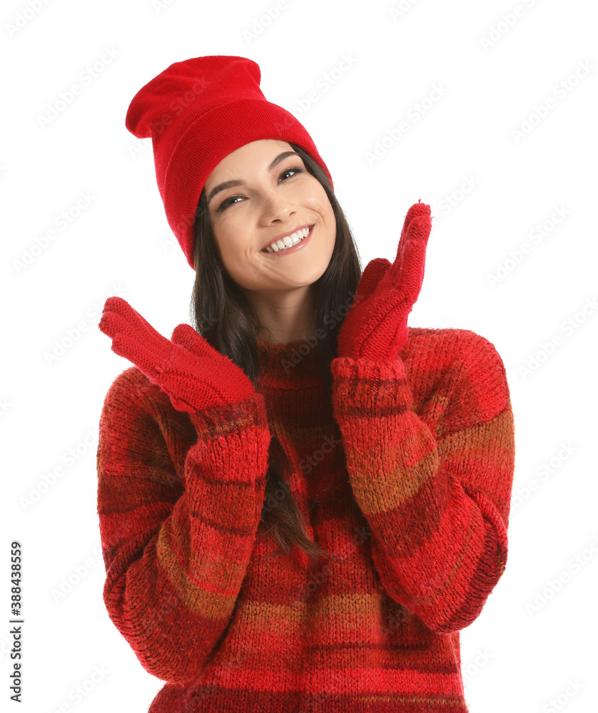Beautiful young woman in winter clothes on white background