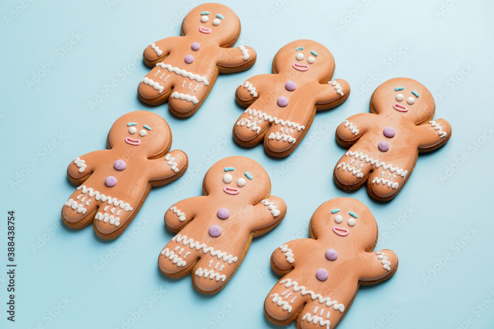 Tasty gingerbread cookies on color background
